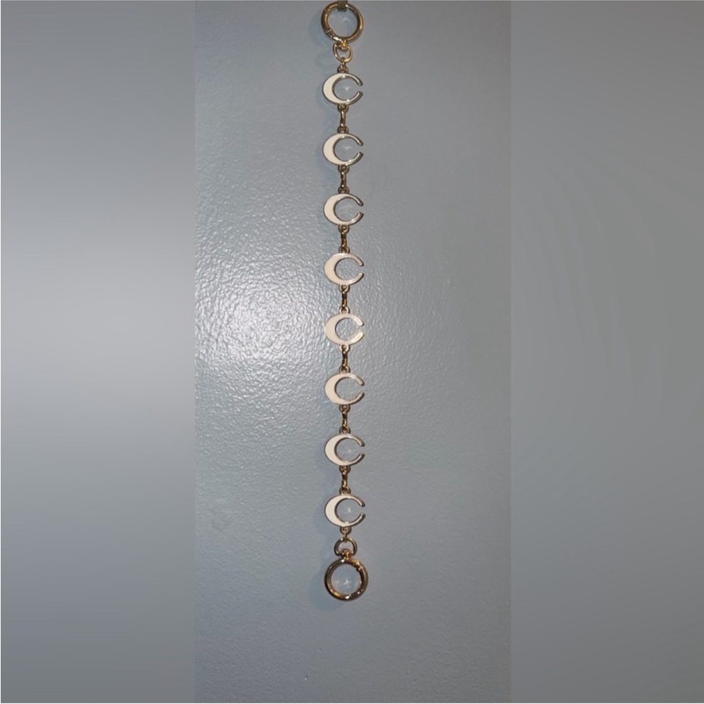 Coach Gold and White Bag Charm